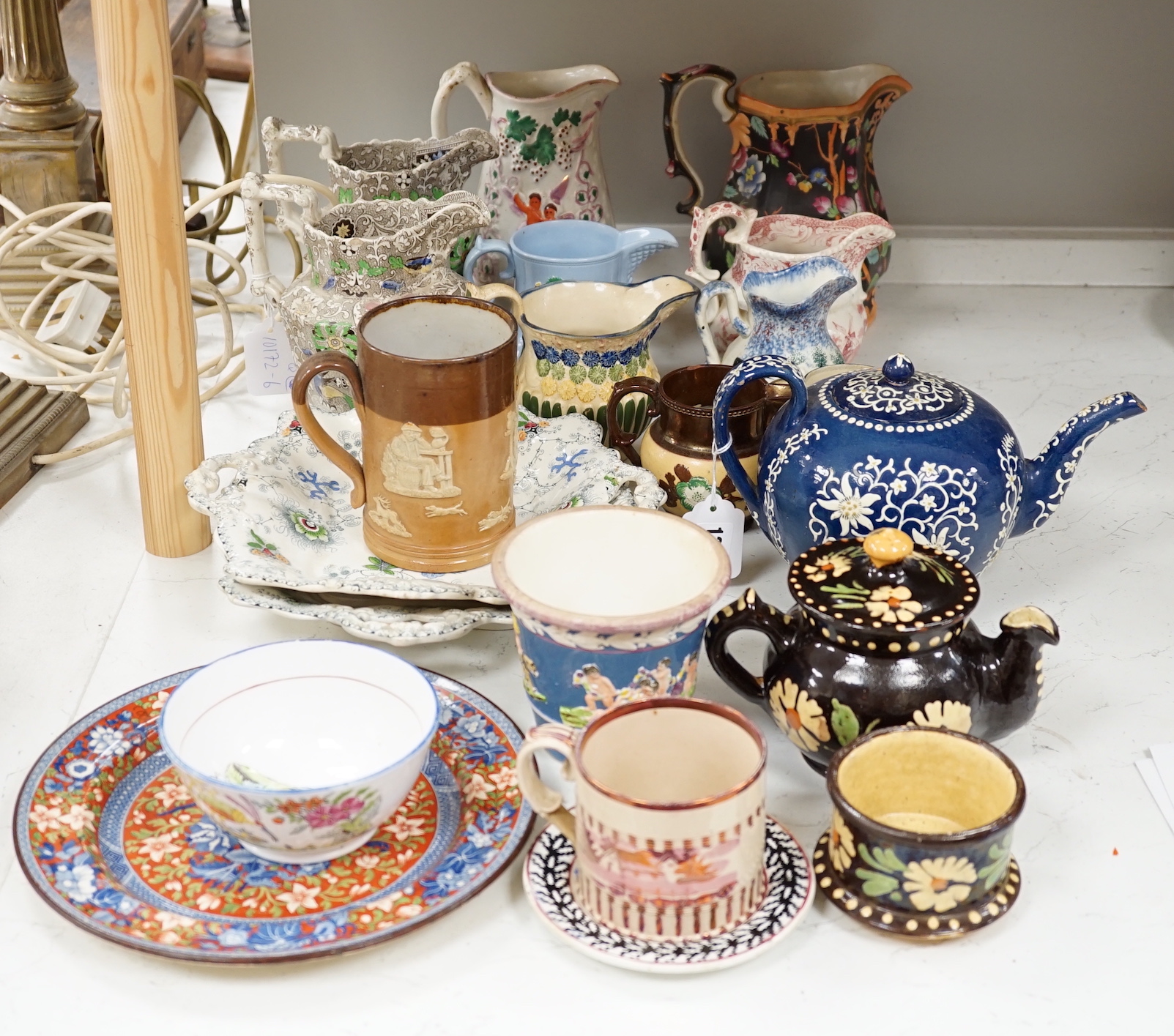 Two Pratt type jugs, an Enoch Wood flower pot, various 19th century pottery jugs, plates etc.